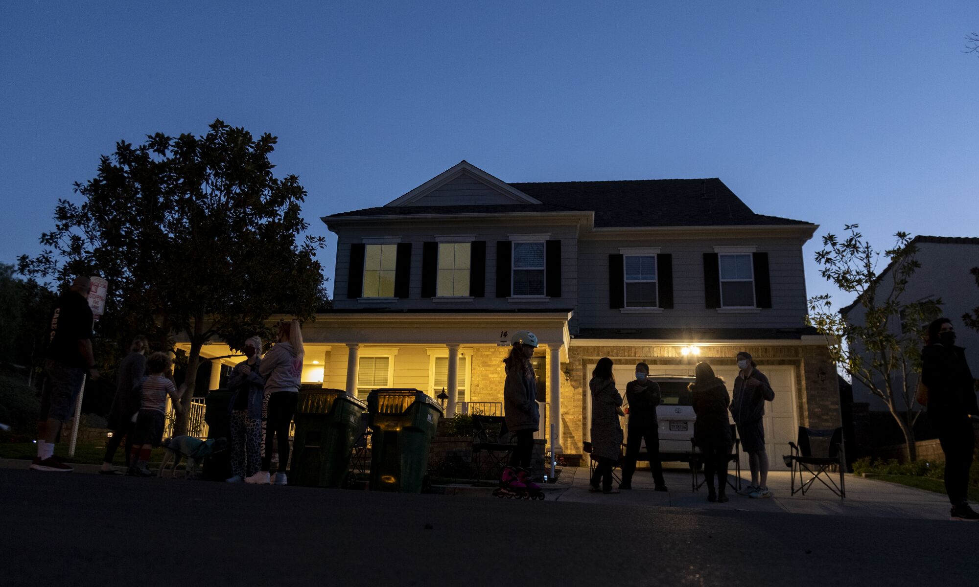 As dusk falls on Haijun Si's home, neighbors gather in front to form a nightly security detail