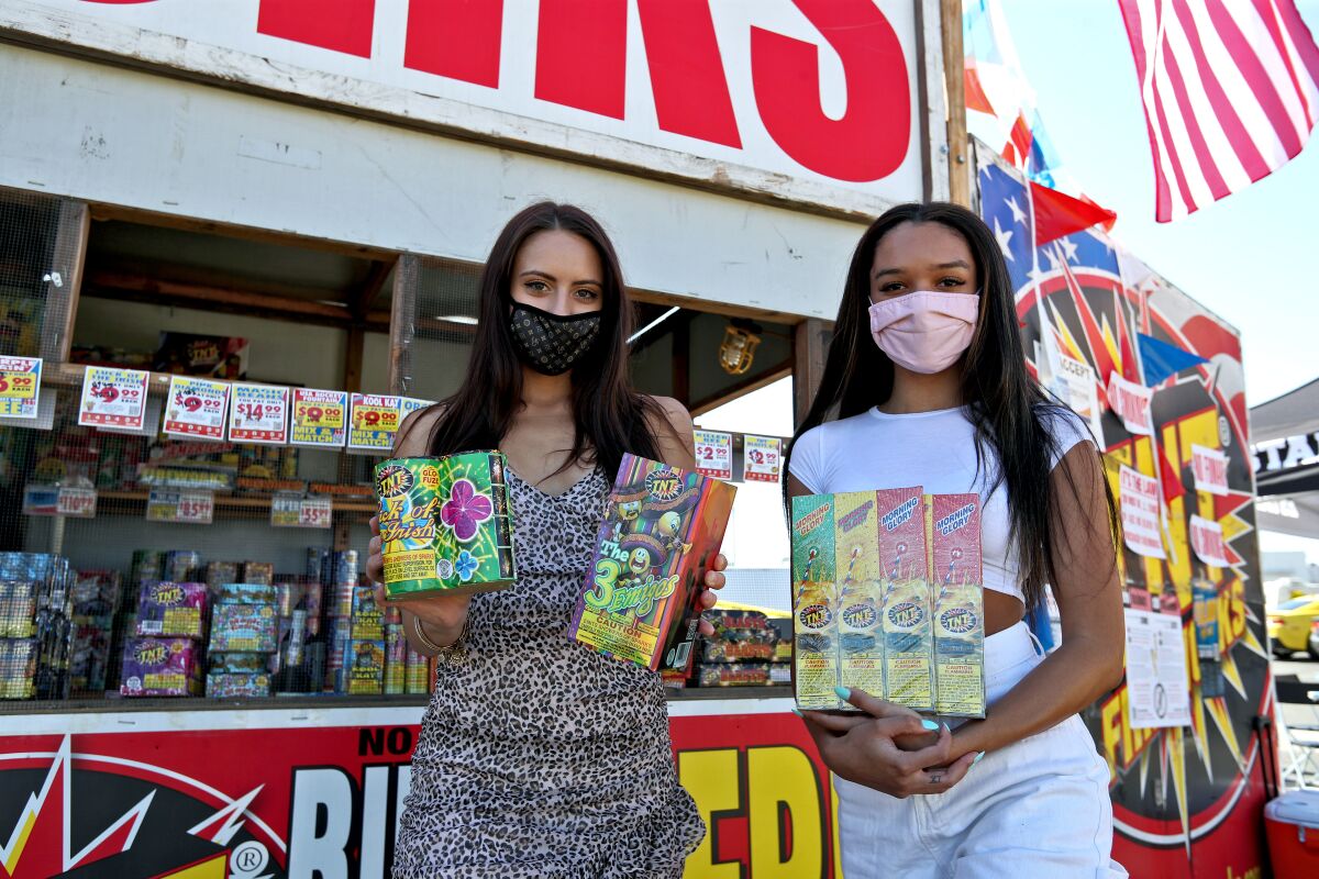Shoppers Maddie Purkis, 21, left, and Taylor Pernicone, 20, looking for fireworks stopped by a TNT Fireworks in Costa Mesa.