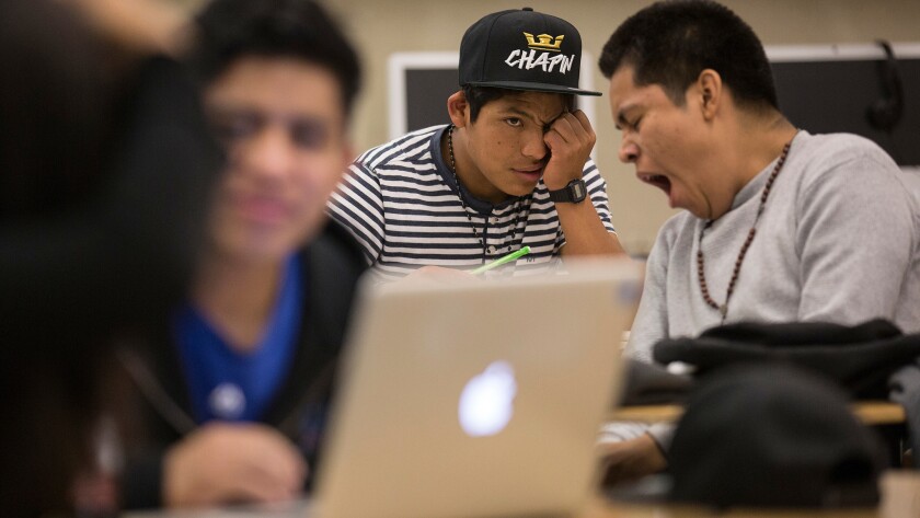 Belmont High student Gaspar Marcos, center, takes in a history lesson despite little sleep.