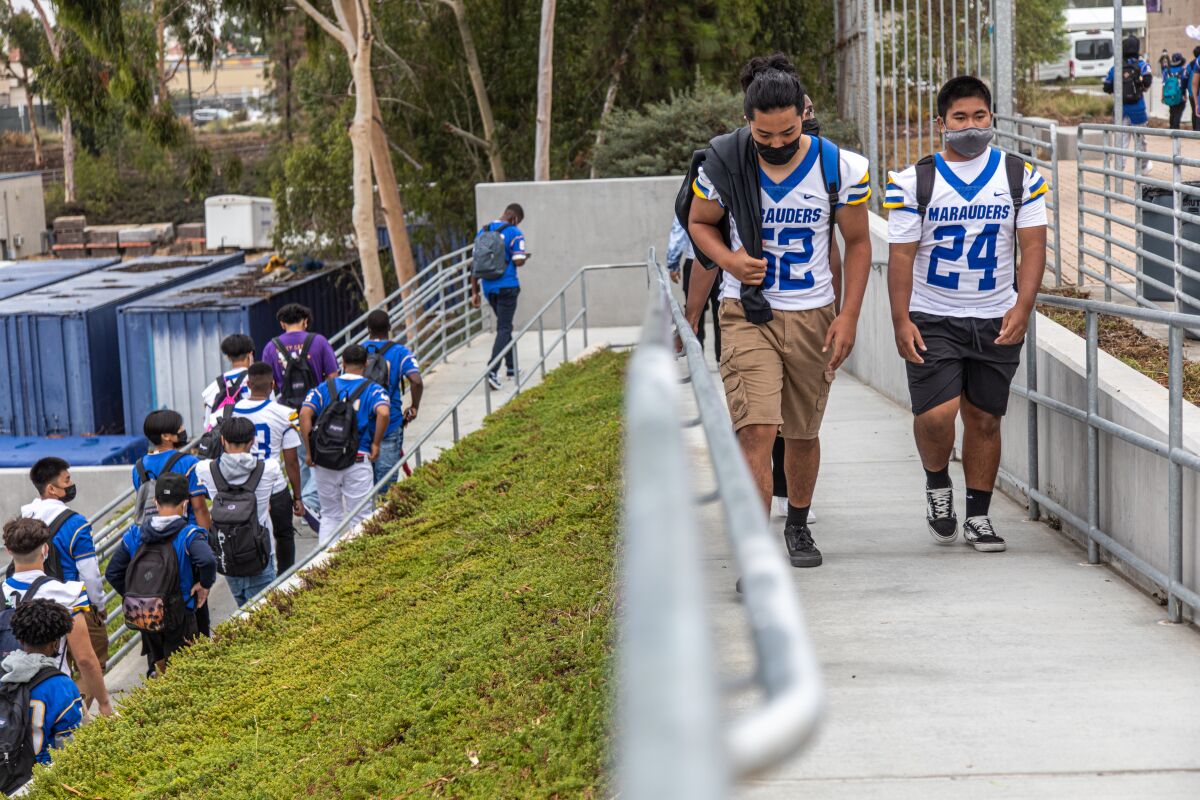 Marauder football players walk to class at Mira Mesa High on Aug. 30, 2021 