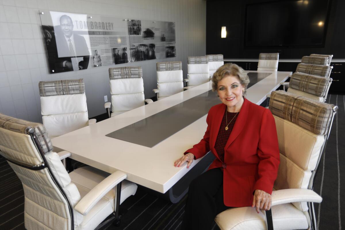 Ap person sits at a table in a conference room.
