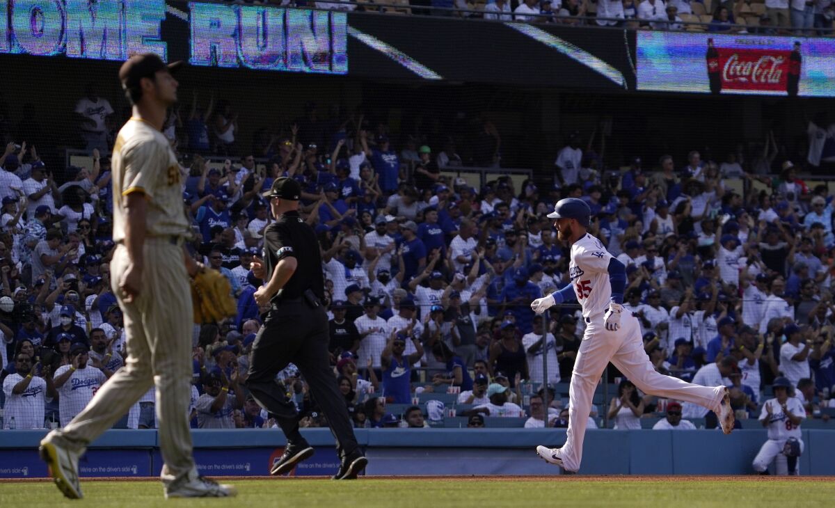 The Dodgers' Cody Bellinger rounds third after hitting a solo home run against Padres pitcher Yu Darvish 