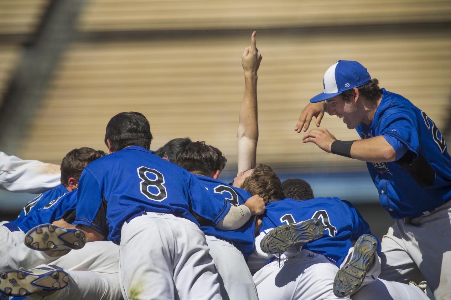 El Camino Real players celebrate after beating Cleveland, 4-3, in the City Section Division I championship Saturday at Dodger Stadium.
