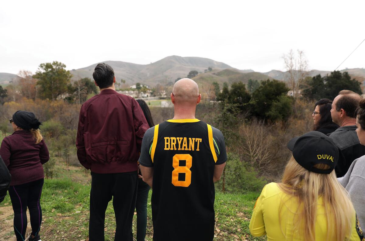 Gennady Grinblat, center, and other fans gathered in Calabasas on Sunday after reports that Kobe Bryant had died in a helicopter crash.
