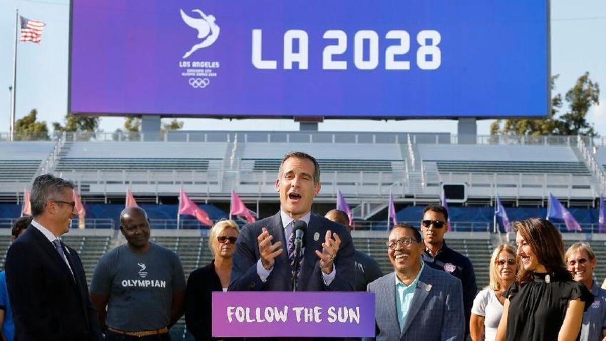 Mayor Eric Garcetti, center, speaks during a news conference about Los Angeles' 2028 Olympic bid.