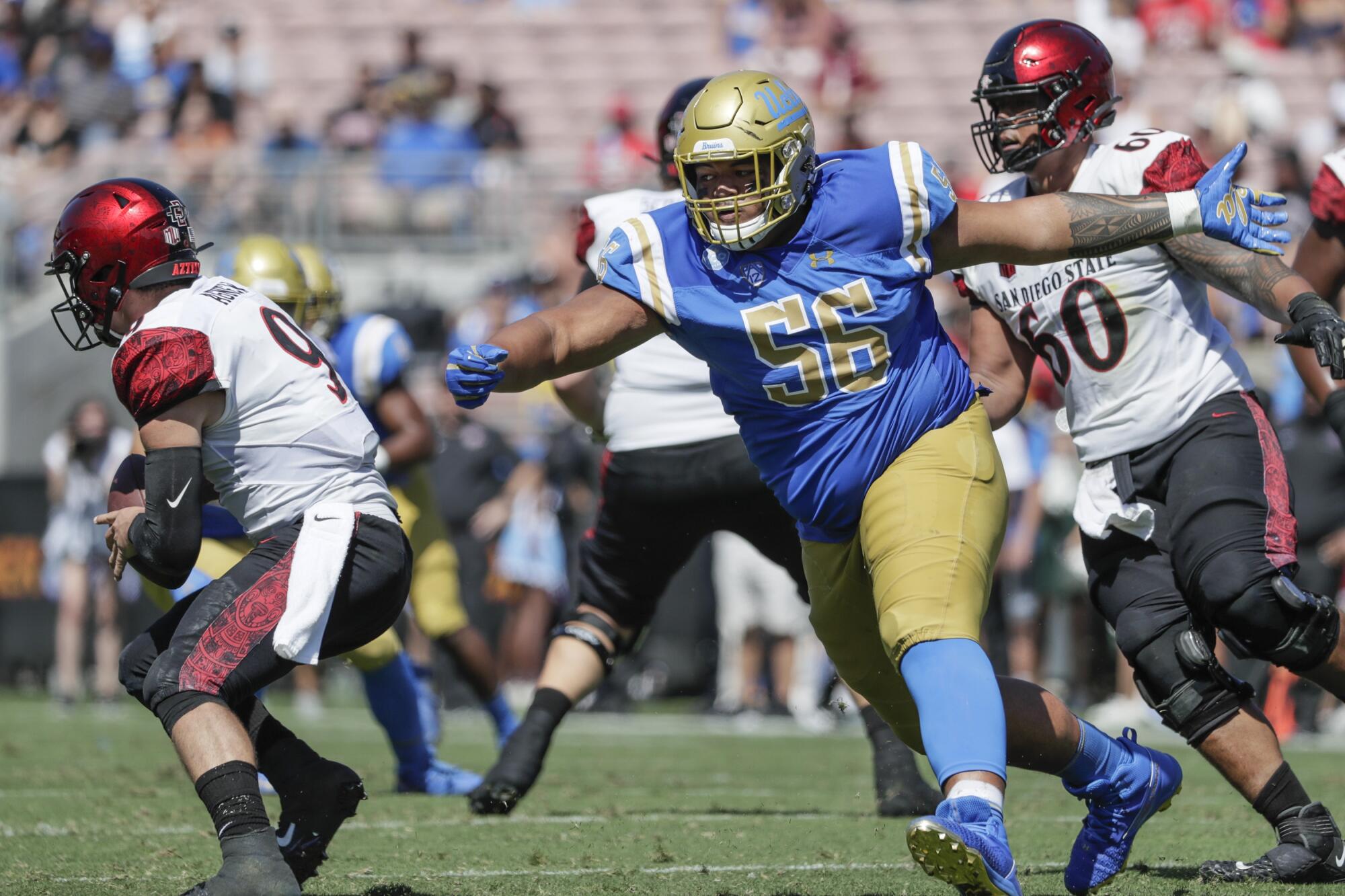 UCLA’S Atonio Mafi leans forward and runs during a game