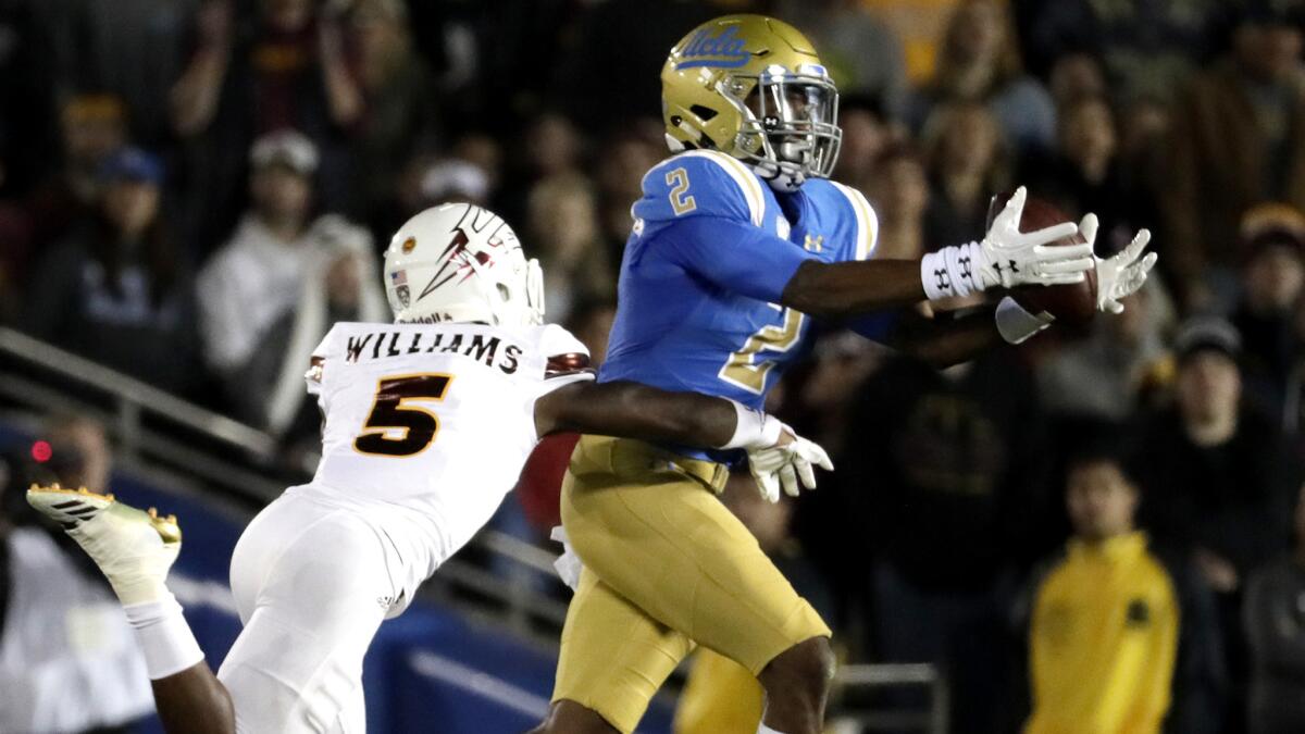 UCLA receiver Jordan Lasley hauls in a long pass from Josh Rosen against Arizona State defensive back Kobe Williams during the second quarter.