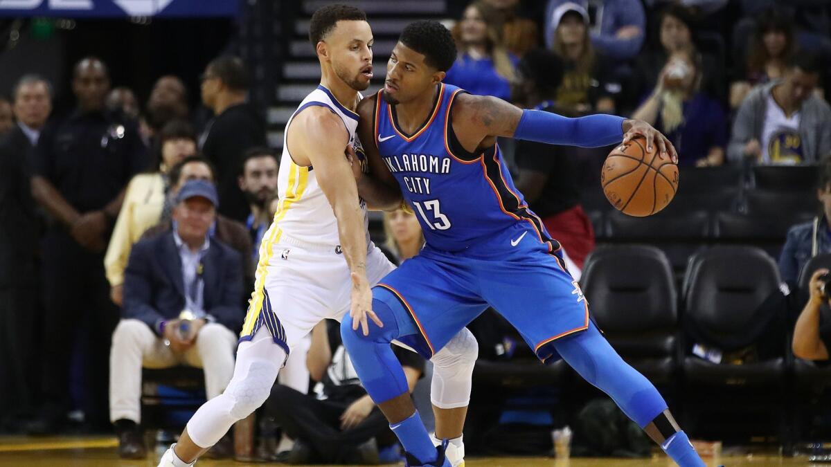 Oklahoma City's Paul George, right, drives with the ball against Golden State's Stephen Curry during the game on Tuesday in Oakland.