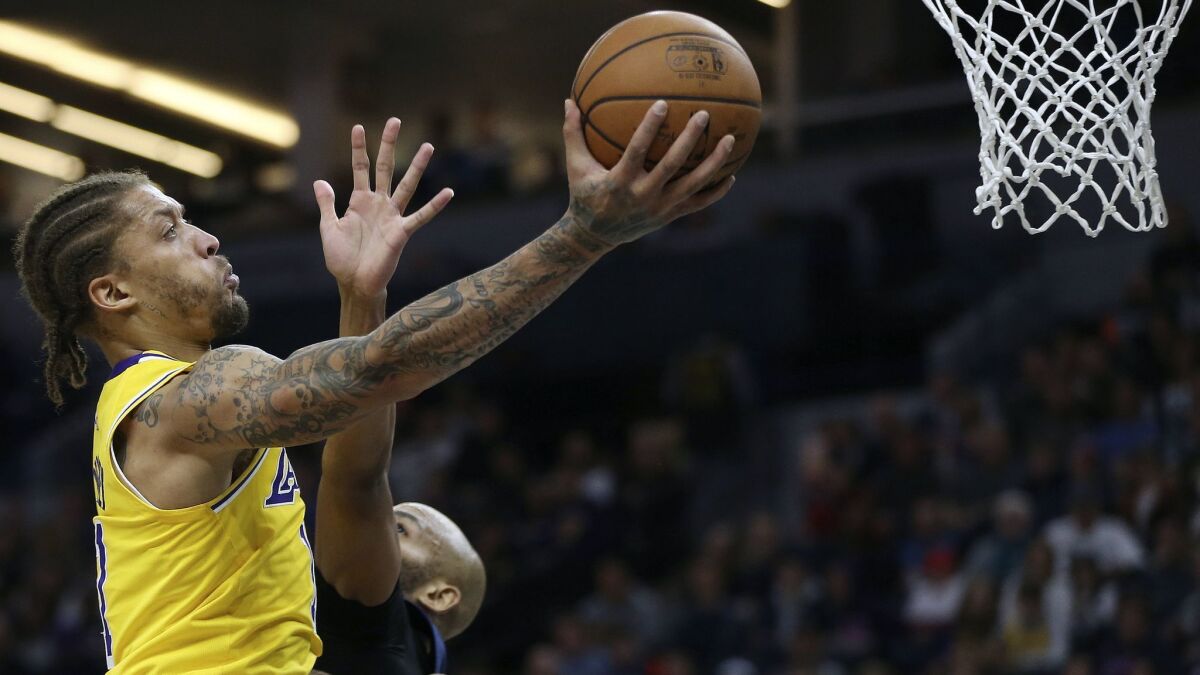 Lakers forward Michael Beasley elevates for a layup over Timberwolves forward Taj Gibson during the second half of a game Sunday.