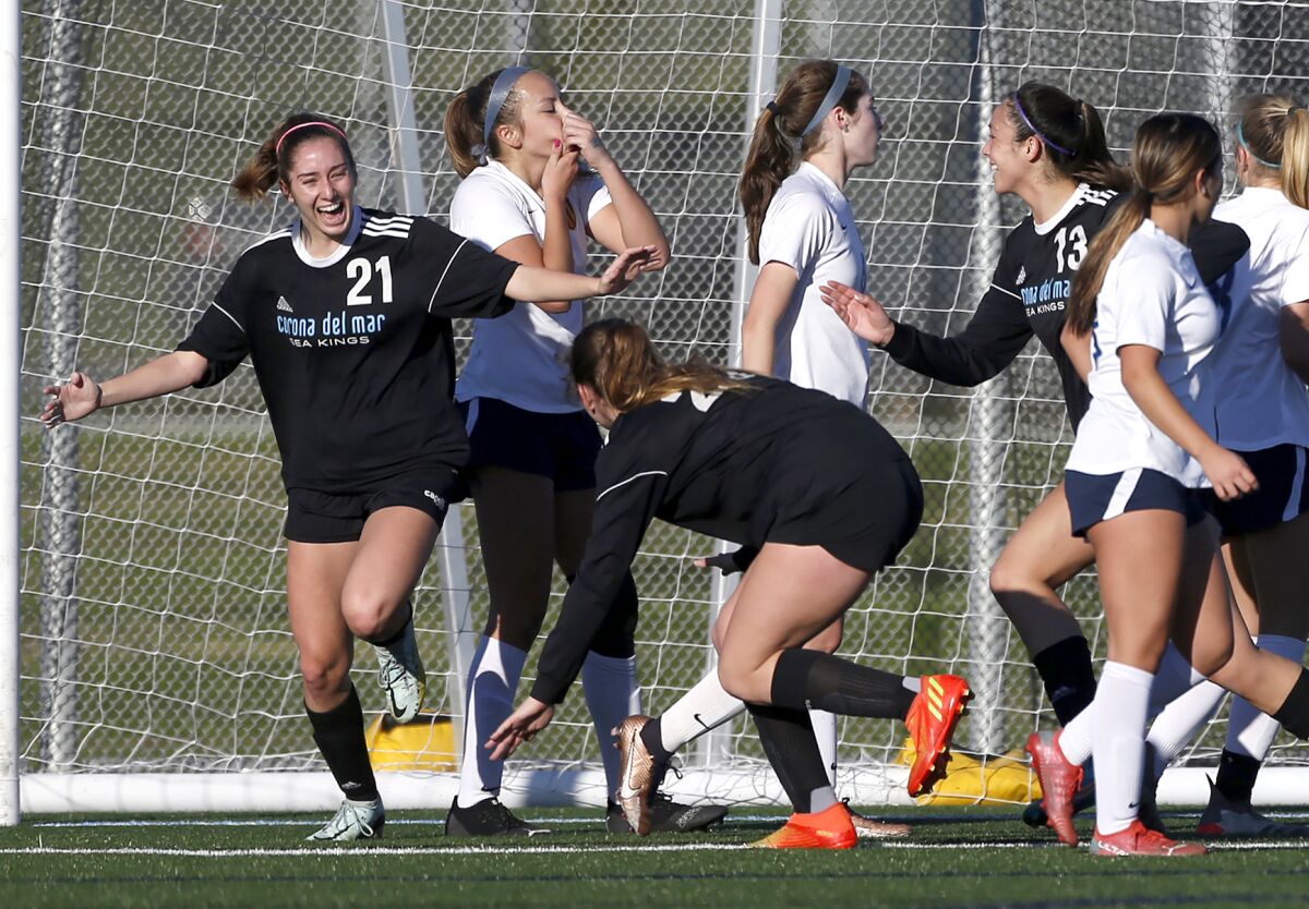 Corona del Mar's Sarah Audiss (21) celebrates with teammates after heading a ball for a goal against Marina on Wednesday.