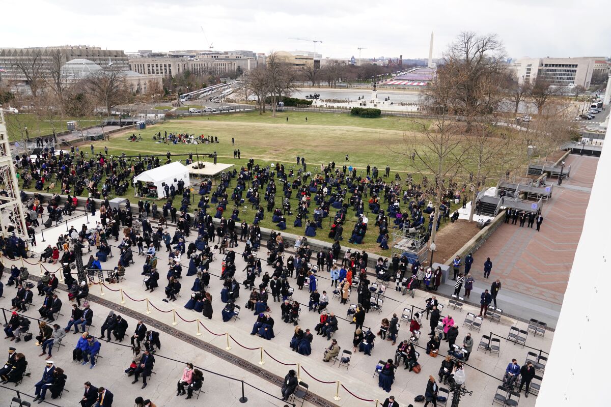 Attendees sit on the West Front of the U.S. Capitol at the 59th presidential inauguration in Washington on Wednesday.
