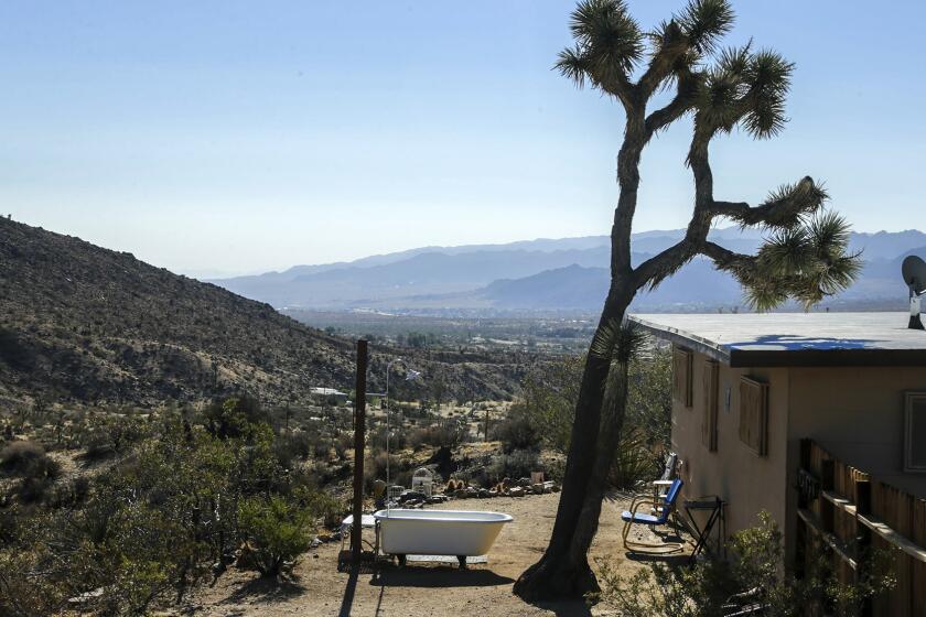 A tiny Yucca Valley homestead cabin, complete with outdoor bathing facilities, is proving popular with renters and providing unexpected income for owners Anne and Darryl Krieghoff.