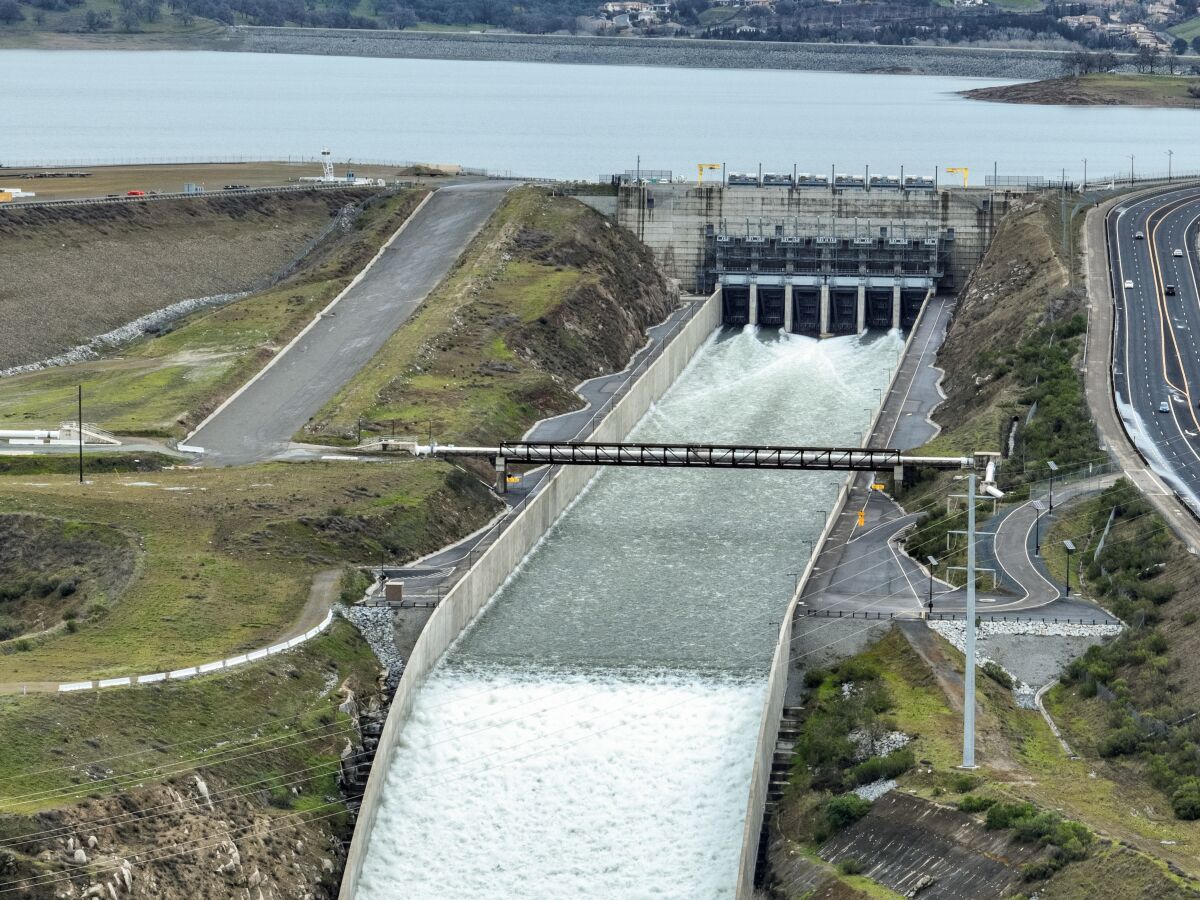 An aerial view of water flowing out of a path from a body of water.