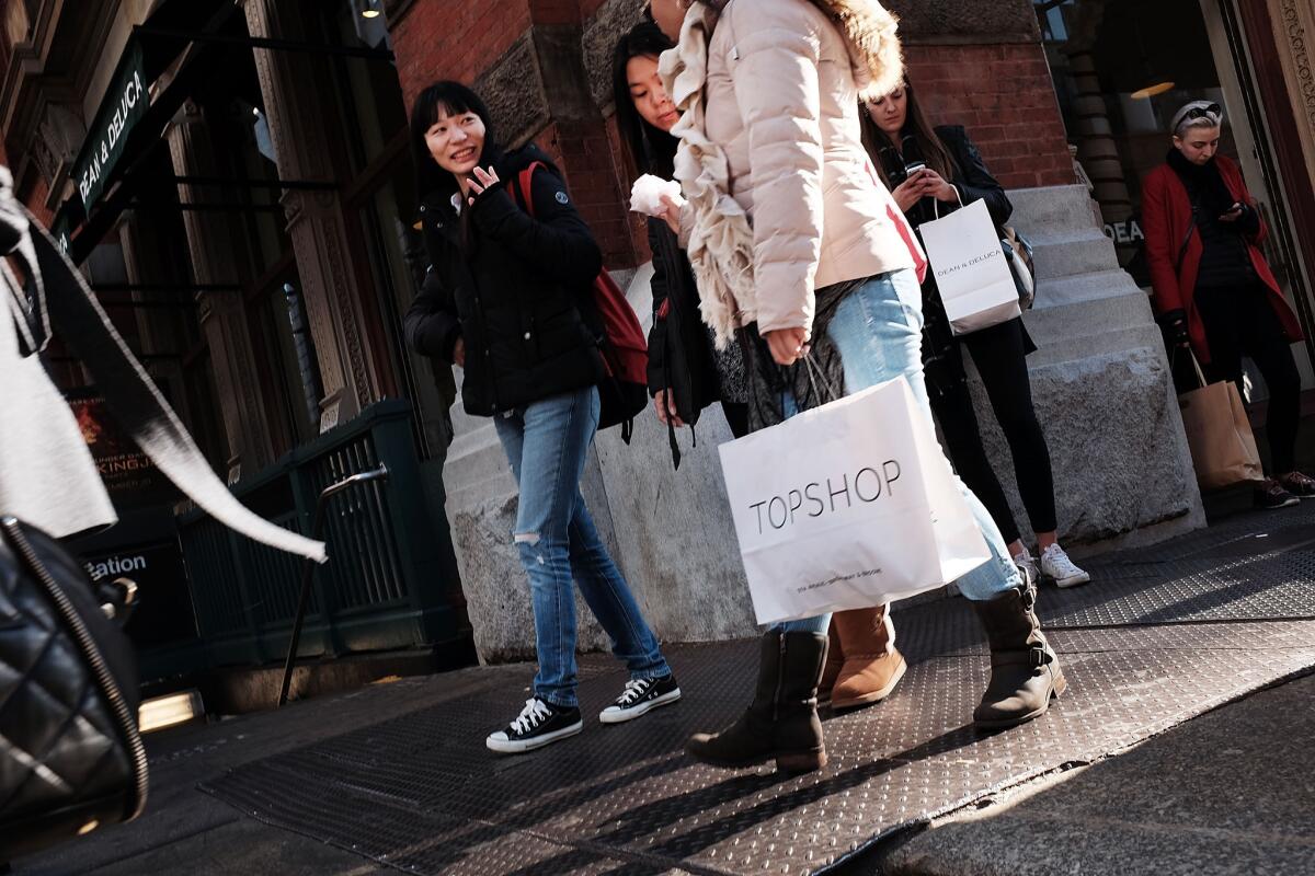 People walk in a shopping district in lower Manhattan in New York City on Nov. 17.