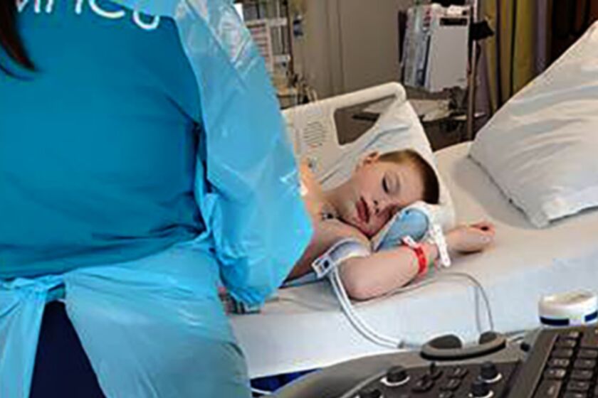 In this 2020 photo provided by Amber Dean 9-year-old Bobby Dean lies on a hospital bed in Rochester, N.Y., after being admitted with severe dehydration, abdominal pain and a racing heart. He tested positive for coronavirus at the hospital and the doctors diagnosed him with a pediatric inflammatory syndrome related to the virus. After six days in the hospital, he was able to go home on Mothers Day. (Dean Family Photo via AP)