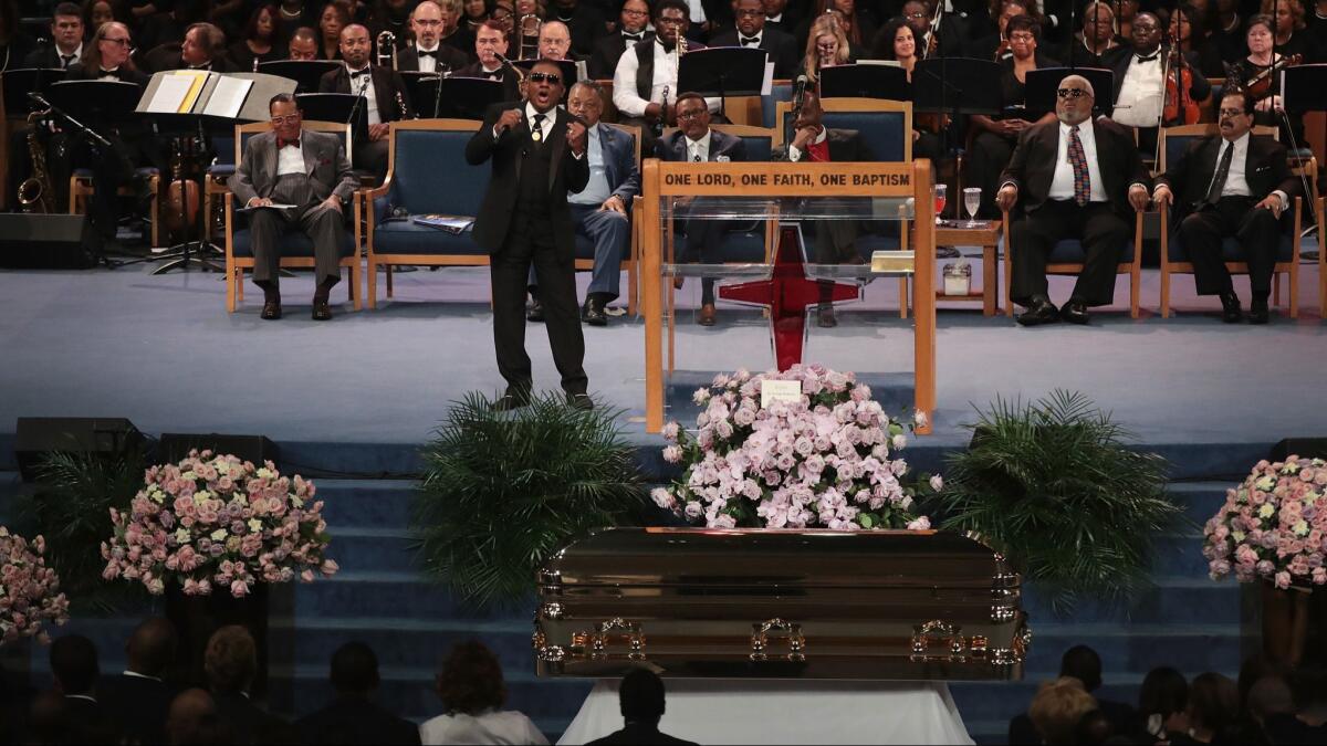 Ron Isley performs within view of Franklin's casket.