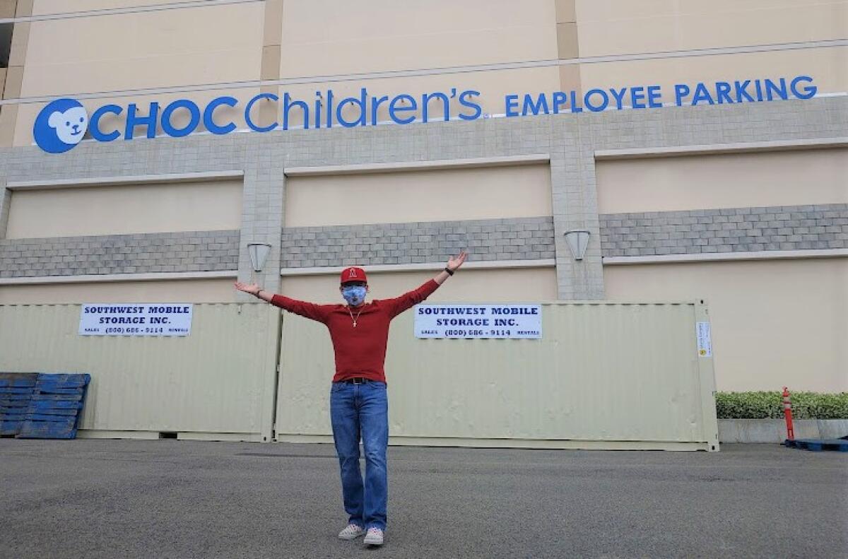 Nolan Torres in front of CHOC Hospital, where he's been a patient for the past 15 years, during a summer internship.