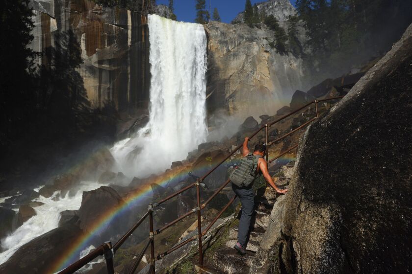 YOSEMITE NATIONAL PARK, CALIFORNIA - APRIL 28: A person climbs a stairway leading to the top of Vernal Fall, with a rainbow visible, as warming temperatures have increased snowpack runoff, on April 28, 2023 in Yosemite National Park, California. Most of Yosemite Valley will close this evening until May 3rd because of forecasted flooding from melting snowpack and extended high temperatures. As of April 1, snowpack in the Tuolumne River basin of Yosemite National Park was 244% of average amid record snowpack levels for some parts of California after years of drought. (Photo by Mario Tama/Getty Images)