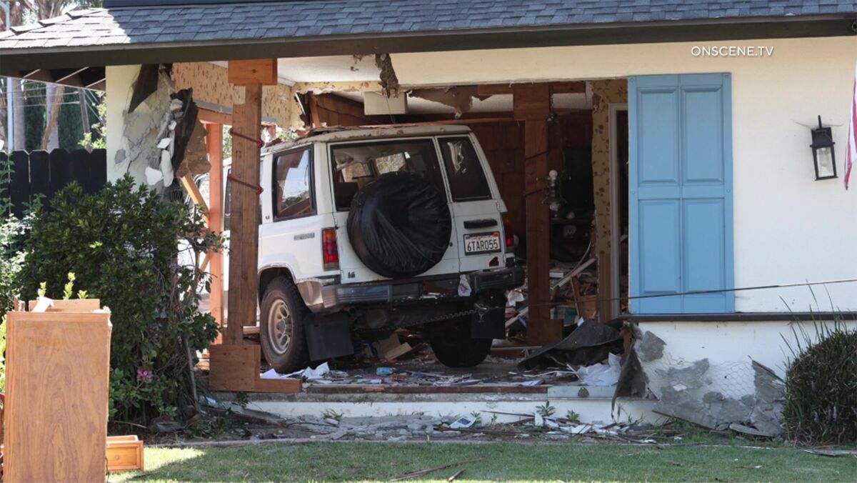 White SUV crashes into a house.