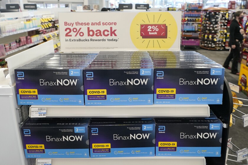 FILE - Boxes of BinaxNow home COVID-19 tests made by Abbott are shown for sale on Nov. 15, 2021, at a CVS store in Lakewood, Wash. The Biden administration's plan for health insurers to reimburse consumers for over-the-counter COVID-19 tests is recalling the model of a bygone era when the companies processed large volumes of claims from individuals _ with paper receipts. (AP Photo/Ted S. Warren, File)