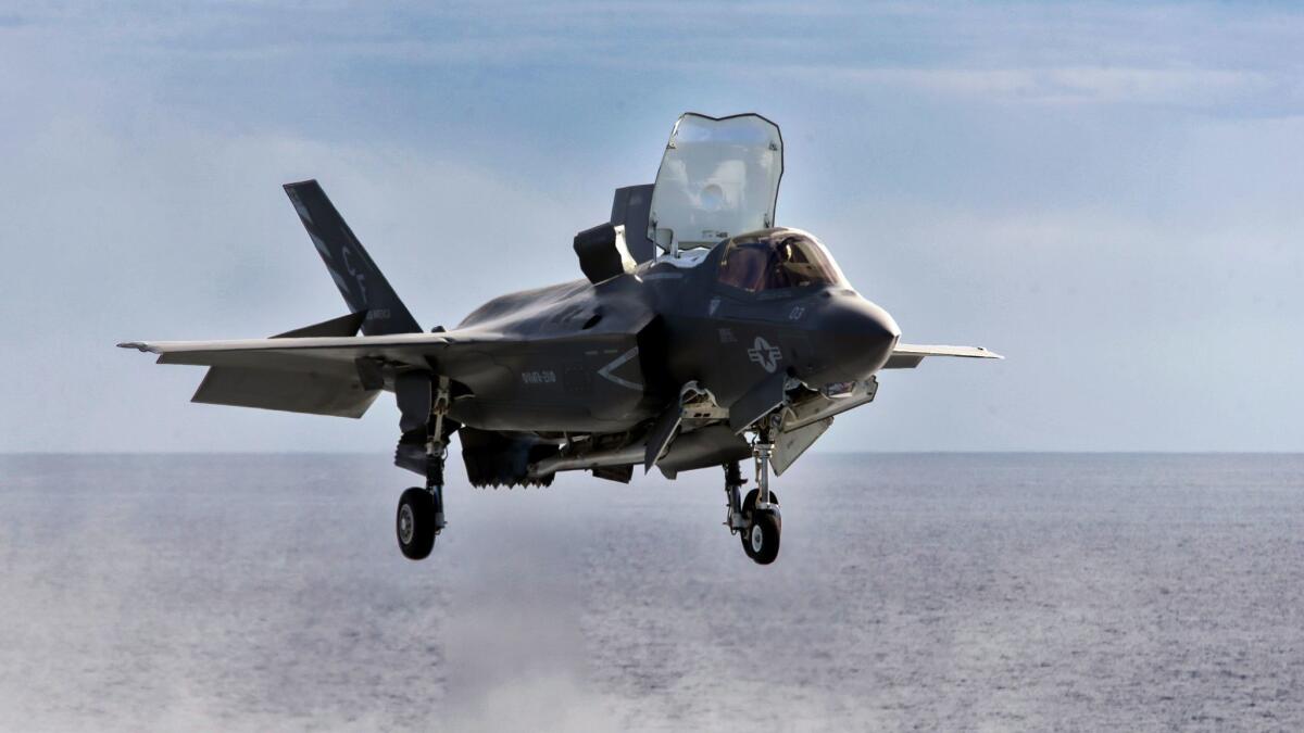 An F-35B Lightning II fighter hovers before landing on the amphibious assault ship America. United Technologies' Pratt & Whitney division supplies the aircraft's engine.
