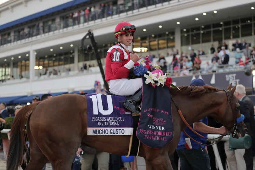 Jockey Irad Ortiz, Jr., atop Mucho Gusto, goes into the Winner's Circle after winning the Pegasus World Cup.