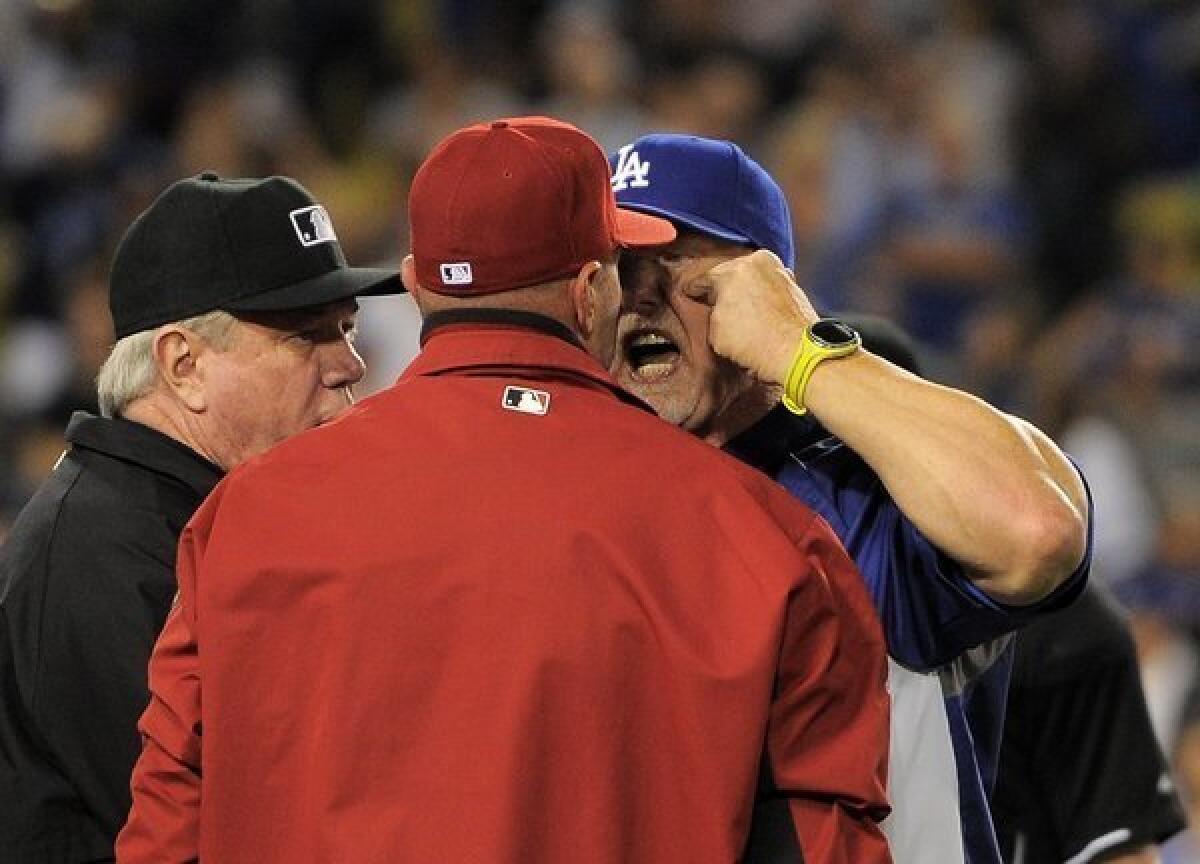 Dodgers batting coach Mark McGwire gets in the face of Arizona Manager Kirk Gibson.