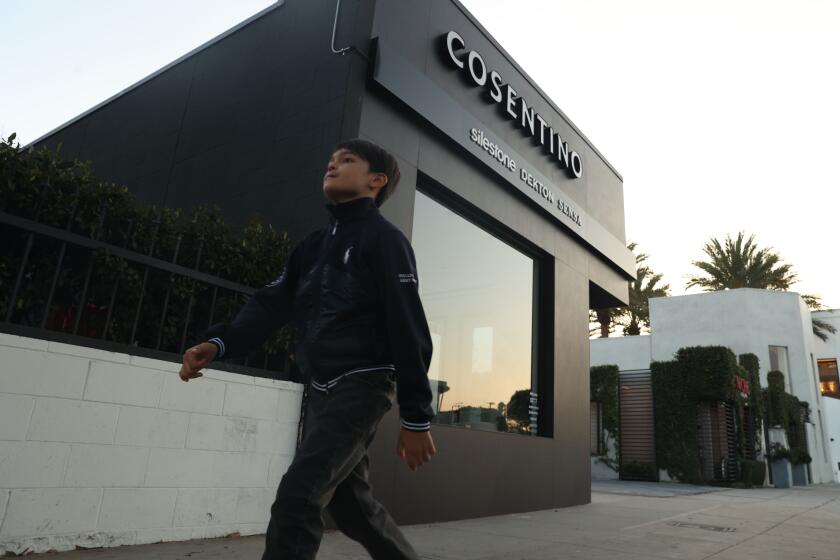 Los Angeles, CA - October 14: A young boy walks by the Cosentino store on Monday, Oct. 14, 2024 in Los Angeles, CA. (Michael Blackshire / Los Angeles Times)