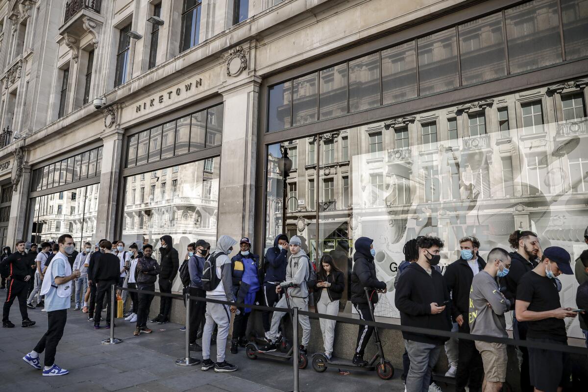 People queue outside the Niketown shop in London on Monday.