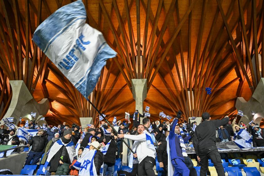 FILE- Israel fans support their team prior the Euro 2024 group I qualifying soccer match between Israel and Romania at the Pancho Arena in Felcsut, Hungary, Saturday, Nov. 18, 2023. Qualifying playoffs for the European Championship in men's soccer start Thursday, March 21, 2024 with strong plotlines among 12 teams playing for three tickets to the tournament in Germany. Israel and Ukraine play “home” games on neutral ground while their countries are involved in wars. They could even meet in a playoff final next week. (AP Photo/Denes Erdos, File)