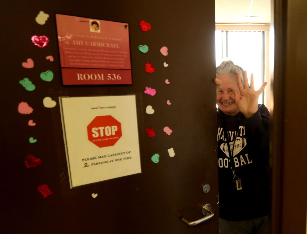 Linda Fett waves goodbye to a visitor from her room at the Union Rescue Mission in Skid Row.