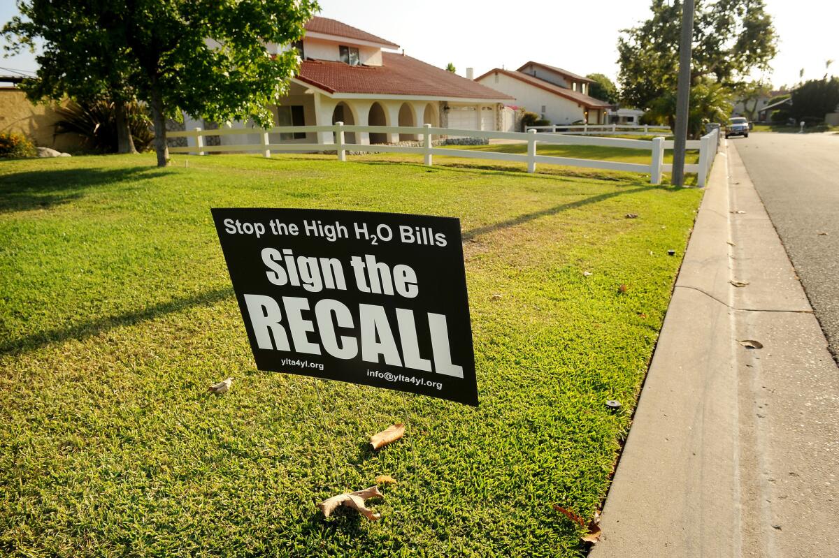 A sign in Yorba Linda urges the recall of water board members who approved a $25 increase in water rates to make up for lost revenue under the state's emergency drought regulations.