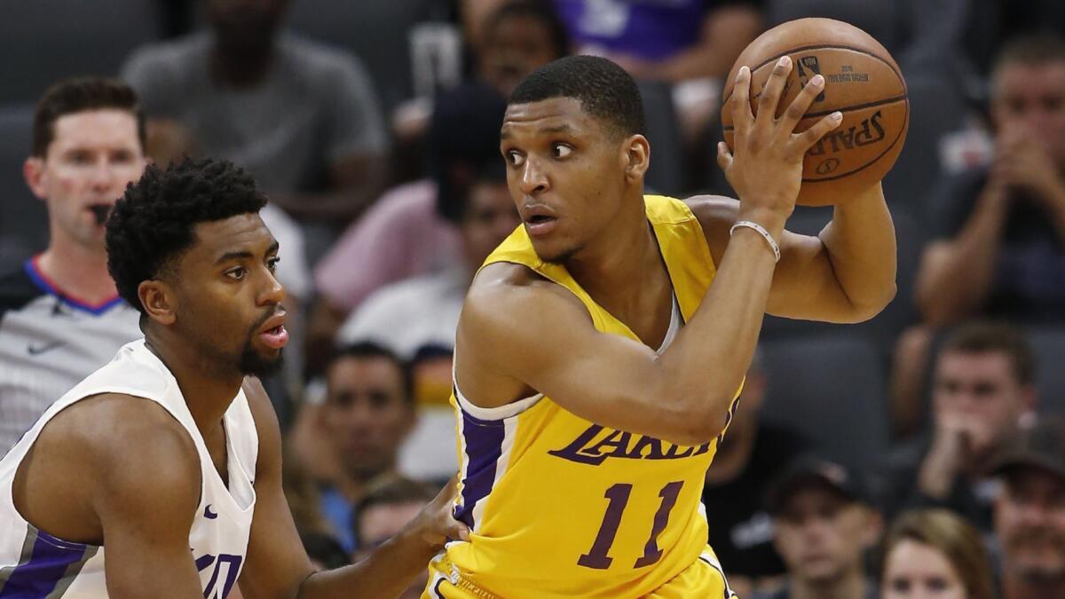 Lakers guard Zach Norvell Jr. protects the ball from the reach of Kings forward Hollis Thompson during a California Classic game Wednesday in Sacramento.