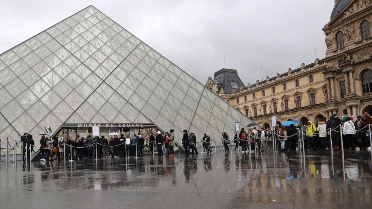 The Louvre Museum reopens on Feb. 4, 2017, a day after a machete-wielding attacker lunged at soldiers who were guarding the entrance.
