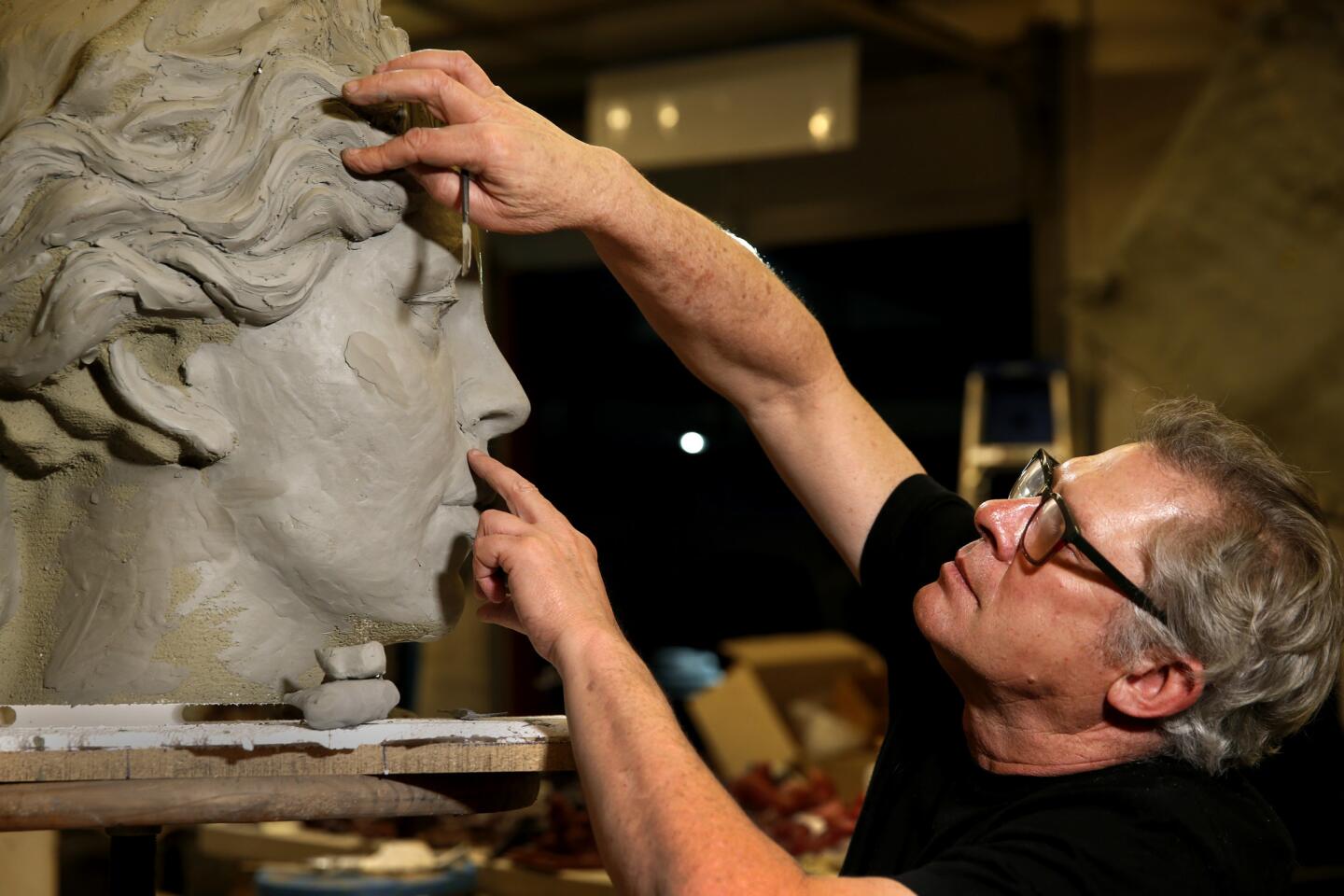 Sculptor Christopher Slatoff works on a full-scale model of Hecuba, queen of Troy, at his studio in Los Angeles.