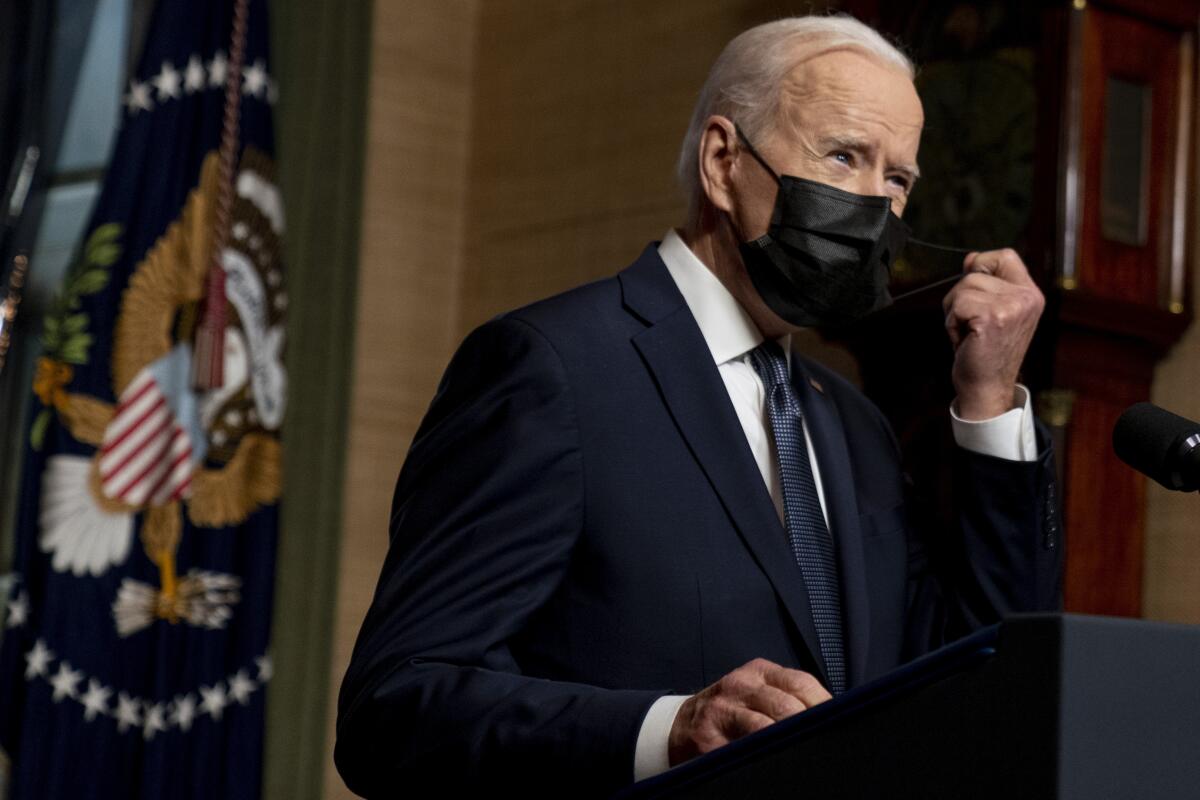 FILE - In this Wednesday, April 14, 2021, file photo, President Joe Biden removes his mask to speak at a news conference at the White House, in Washington. Ten liberal senators are urging Biden to back India and South Africa’s appeal to the World Trade Organization to temporarily relax intellectual property rules so coronavirus vaccines can be manufactured by nations that are struggling to inoculate their population. (AP Photo/Andrew Harnik, Pool, File)