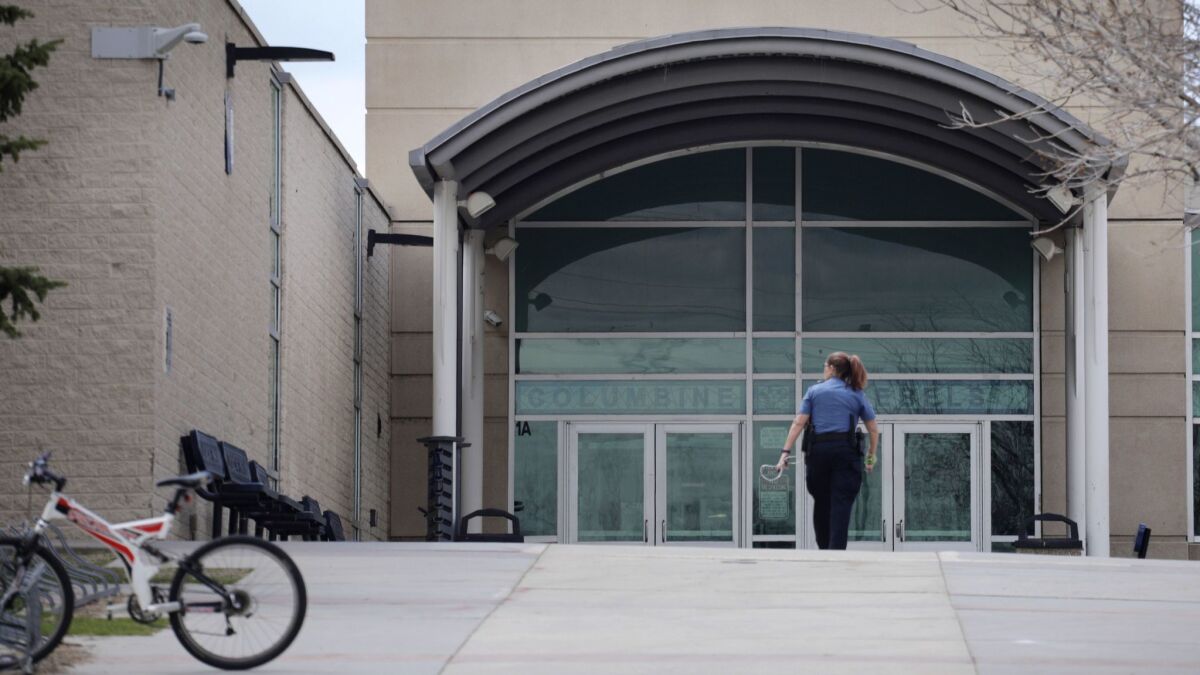 A police officer walks to the front doors of Columbine High School on April 17 in Littleton, Colo.