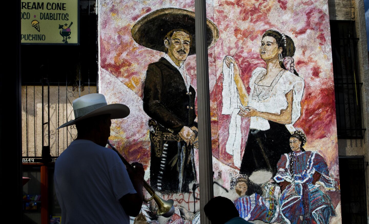 Mariachi player Natolio Nuñez, who has been playing trumpet for 40 years, practices in the shade in Mariachi Plaza in Boyle Heights.