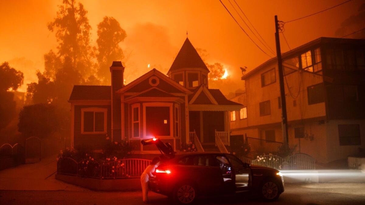 A family packs up and evacuates as a brushfire gets closer to their home in Ventura.