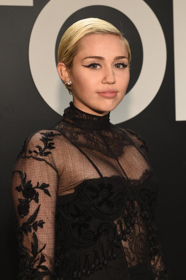 Miley Cyrus, wearing Tom Ford, on the red carpet at the designer's fall-winter 2015 presentation in Los Angeles on Feb. 20, 2015.