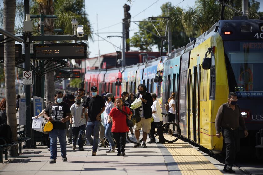 SAN YSIDRO, CALIFORNIA - JULY 30: The 10 San Diego County ZIP codes with the most cases have been atop the list of local COVID hotspots since early May. Commuters coming off the San Diego Trolley at San Ysidro Border area on Thursday, July 30, 2020 in San Ysidro, California. (Alejandro Tamayo / The San Diego Union-Tribune)