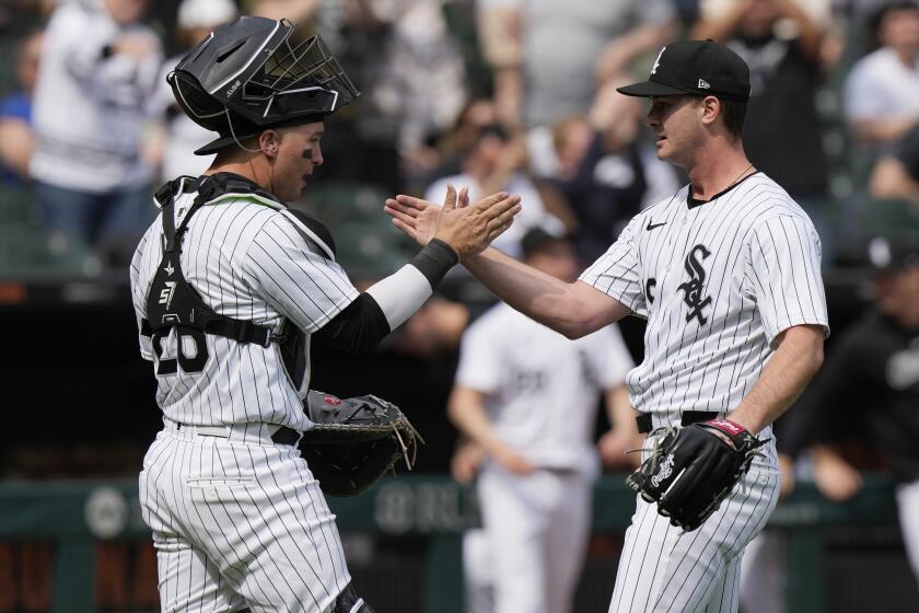 Chicago White Sox catcher Korey Lee, left, celebrates with relief pitcher Jordan Leasure after the White Sox defeated the Tampa Bay Rays in a baseball game in Chicago, Sunday, April 28, 2024. (AP Photo/Nam Y. Huh)