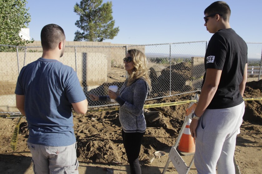 Virginia Driscoll, center, mother of Robert Michael Rasmussen, visits the site with other family members near the 12-foot-deep culvert in Palmdale where authorities excavated Rasmussen's body.