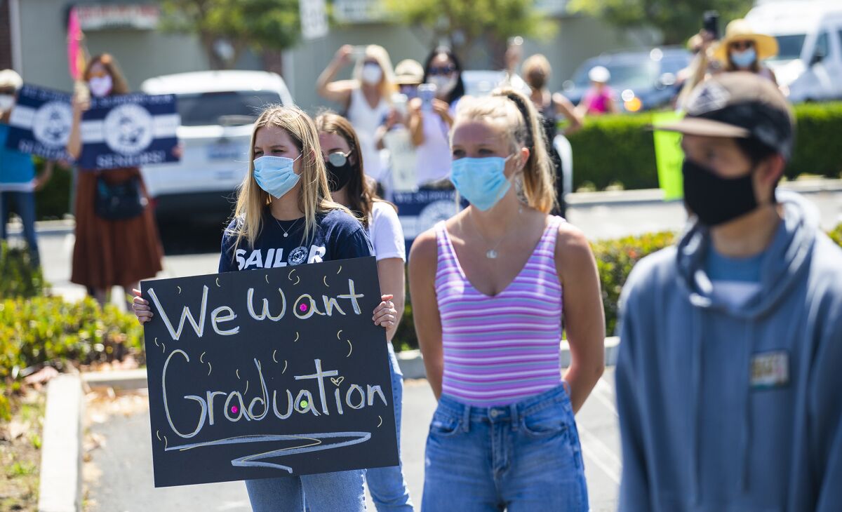 Students outside of the school district office in Costa Mesa on Tuesday protest the Newport-Mesa Unified School District's decision to not hold in-person graduation ceremonies this year because of the COVID-19 pandemic.