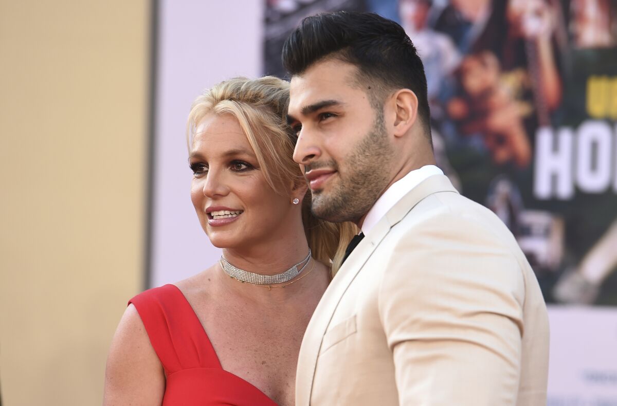 Britney Spears and Sam Asghari arrive at the Los Angeles premiere of "Once Upon a Time in Hollywood," at the TCL Chinese Theatre, Monday, July 22, 2019. Spears announced on Instagram on Sunday, Sept. 12, 2021, that she and Asghari are engaged. The couple met on the set of her “Slumber Party” music video in 2016. (Photo by Jordan Strauss/Invision/AP, File)