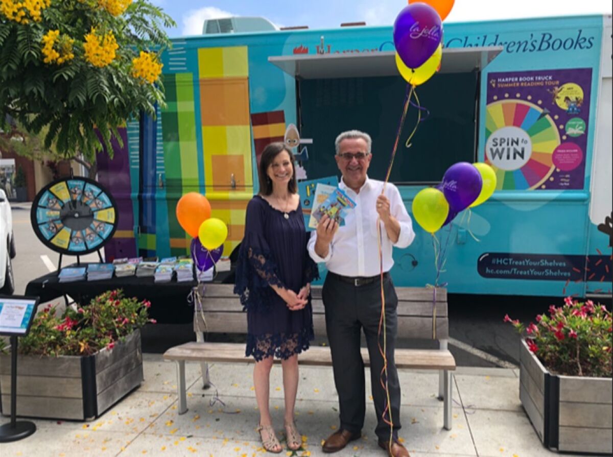 Warwick's bookstore owner Nancy Warwick and San Diego City Councilman Joe LaCava check out the HarperCollins Book Truck. 