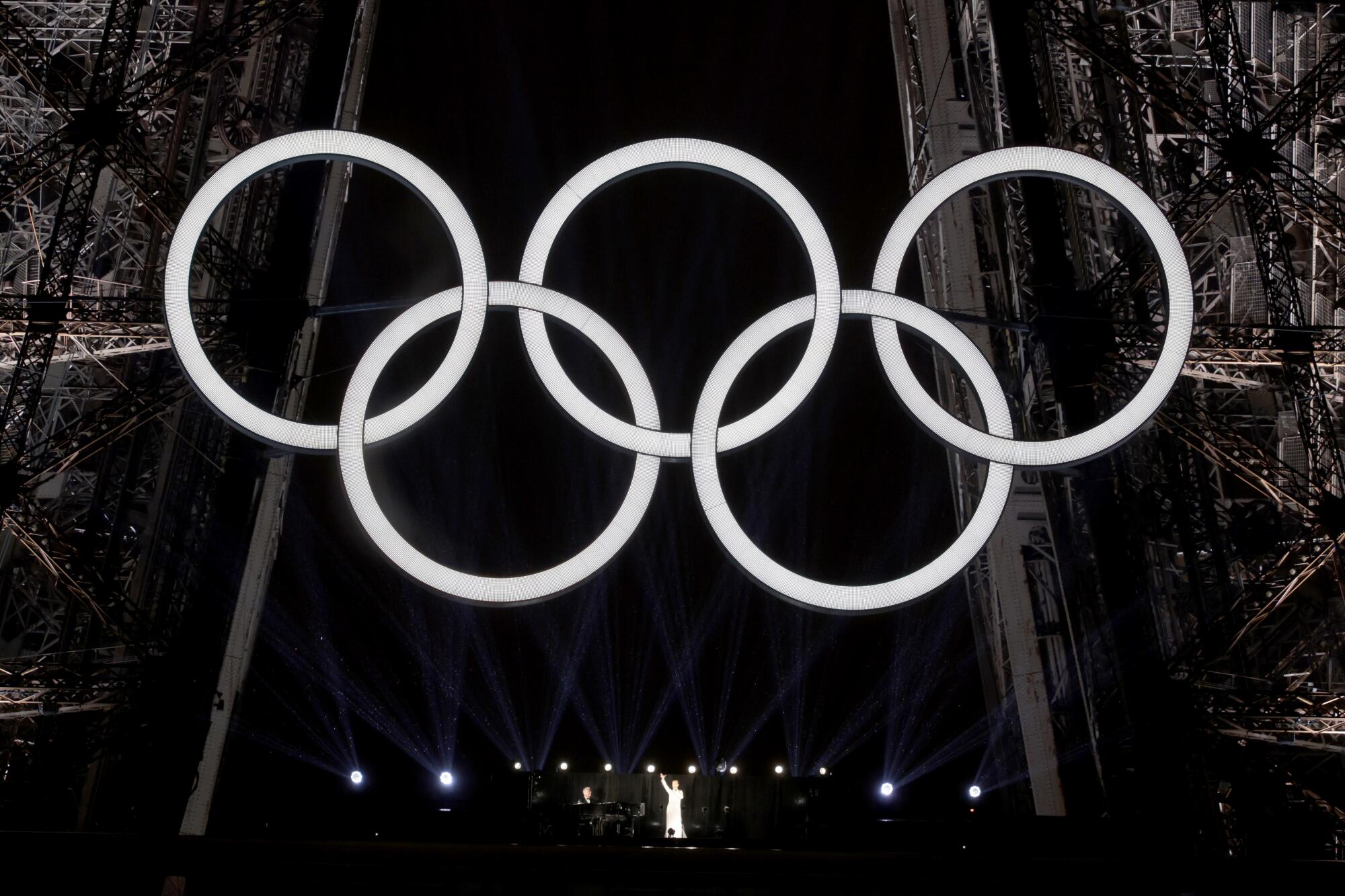 Canadian singer Celine Dion performs on the Eiffel Tower at the end of the Olympics opening ceremony on Friday.
