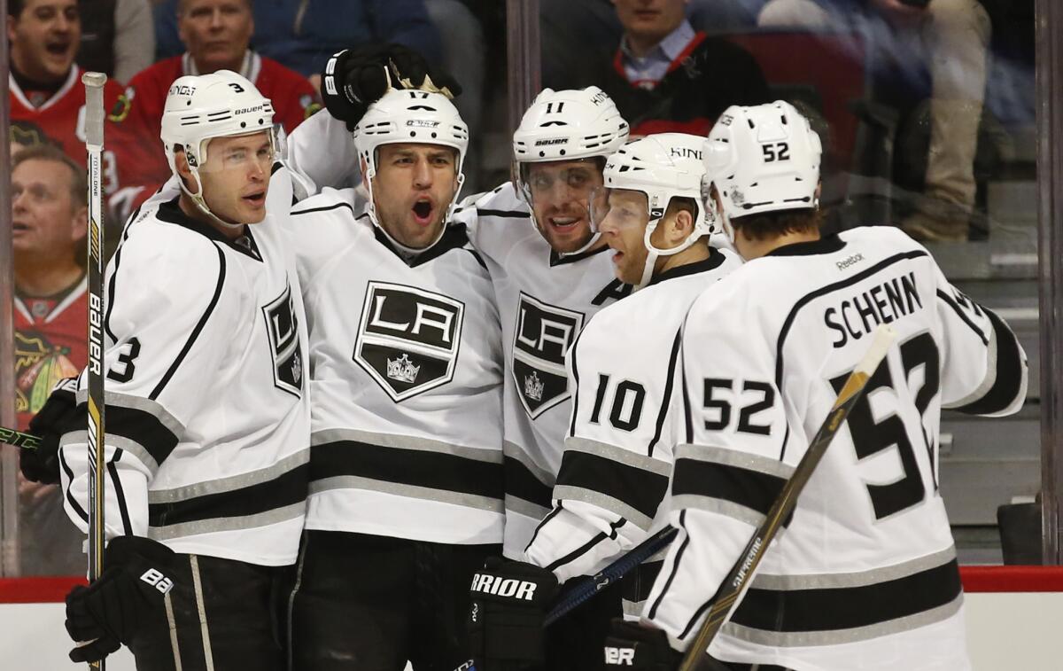 Kings left wing Milan Lucic, second left, celebrates with teammates after scoring a goal aginast the Blackhawks in the first period.