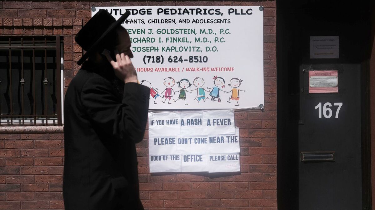 A sign outside a pediatricians' office warns of measles in an ultra-Orthodox Jewish community in New York City.