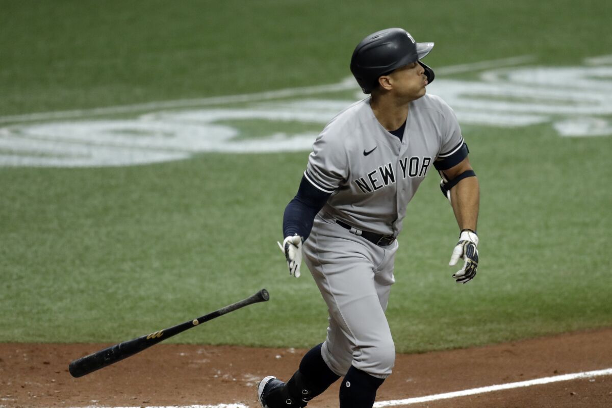 New York Yankees' Giancarlo Stanton drops his bat as he watches his solo home run off Tampa Bay Rays pitcher Sean Gilmartin during the fifth inning of the first game of a doubleheader baseball game Saturday, Aug. 8, 2020, in St. Petersburg, Fla. (AP Photo/Chris O'Meara)